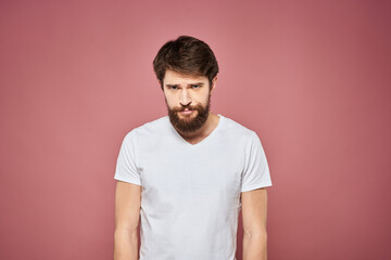 Obraz premium Man in white t-shirt emotions lifestyle facial expression cropped view pink background.