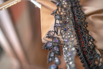 four beaded bracelet on beige background