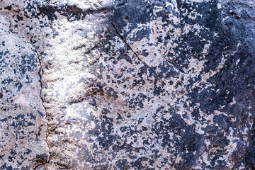 Natural stone background with cracks and scratches texture.