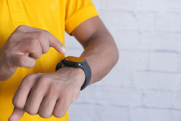 top view of man's hand using smart watch.