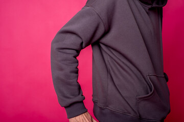 parts of hoodie clothing on a multicolored background dressed on men