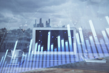 Fototapeta premium Forex Chart hologram on table with computer background. Multi exposure. Concept of financial markets.