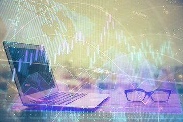 Stock market graph on background with desk and personal computer. Multi exposure. Concept of financial analysis.