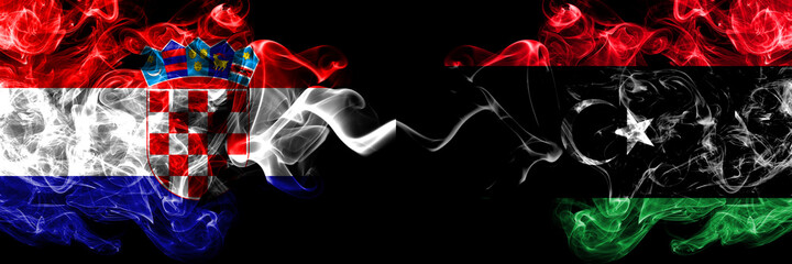Croatia, Croatian vs Libya, Libyan smoky mystic flags placed side by side. Thick colored silky abstract smoke flags.