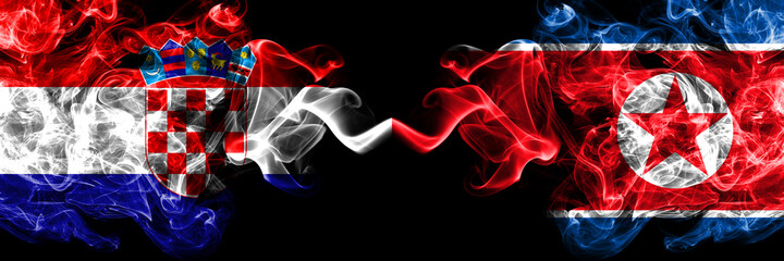 Croatia, Croatian vs North Korea, Korean smoky mystic flags placed side by side. Thick colored silky abstract smoke flags.