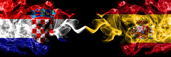 Croatia, Croatian vs Spain, Spanish smoky mystic flags placed side by side. Thick colored silky abstract smoke flags.