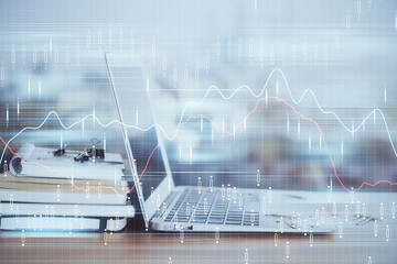 Stock market chart hologram drawn on personal computer background. Double exposure. Concept of investment.