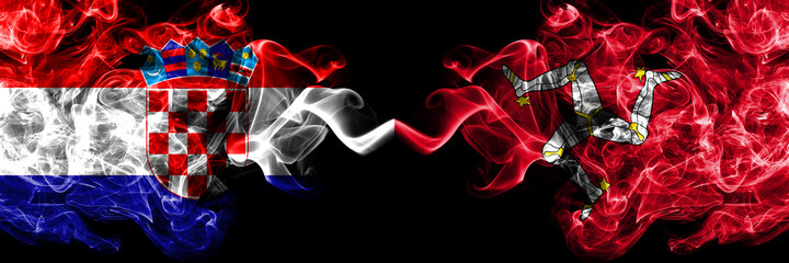 Croatia, Croatian vs United Kingdom, Great Britain, British, Isle of Mann  smoky mystic flags placed side by side. Thick colored silky abstract smoke flags.