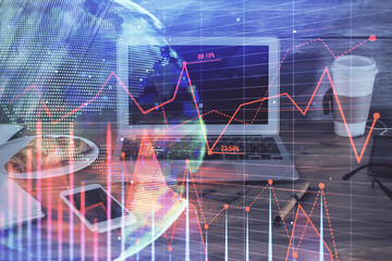 Double exposure of chart and financial info and work space with computer background. Concept of international online trading.