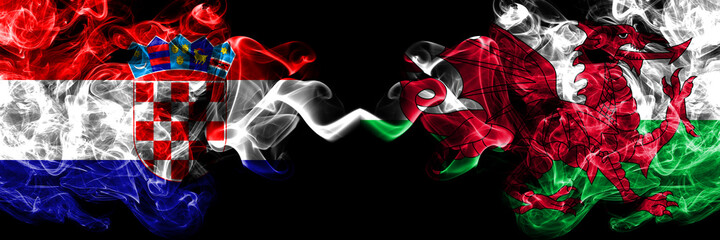 Croatia, Croatian vs Wales, United Kingdom smoky mystic flags placed side by side. Thick colored silky abstract smoke flags.