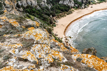 Mountains of steel and stones on the seashore. Wild beach. holidays, privacy