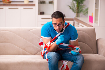 Young man suffering at home in pandemic concept