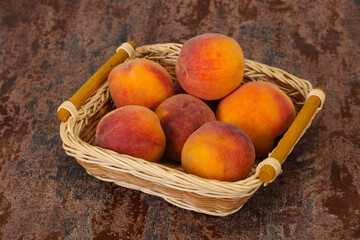 Peach heap in the wooden basket