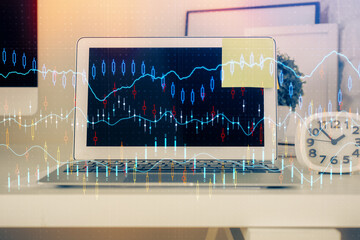 Financial graph colorful drawing and table with computer on background. Double exposure. Concept of...