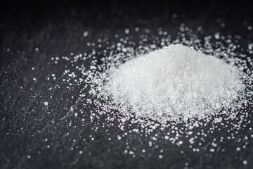 citric acid on a dark stone background