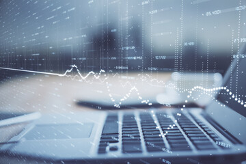 Financial chart drawing and table with computer on background. Multi exposure. Concept of international markets.