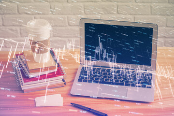 Double exposure of graph and financial info and work space with computer background. Concept of...