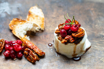 Christmas cheese with nuts, figs and cranberry topping