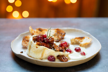 Melted goats cheese with Christmas nuts and fruits