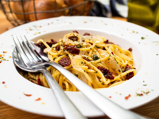 Pasta with parmesan and vegetables on wooden table
