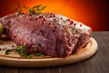 Fresh raw pork on cutting board on gradient color background
