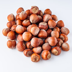 fresh natural hazelnuts on a white acrylic background