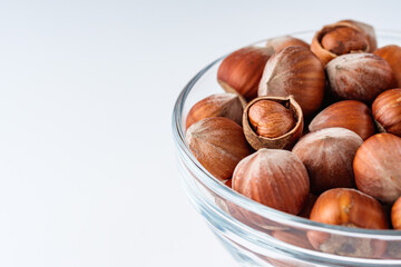 fresh natural hazelnuts on a white acrylic background