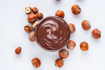 chocolate butter and hazelnuts on a white acrylic background