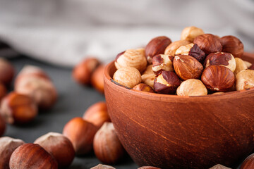fresh natural hazelnuts on a dark stone background