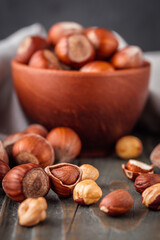 fresh natural hazelnuts on a dark wooden rustic background