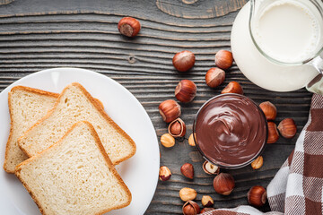 toasts with chocolate butter on a dark wooden rustic background