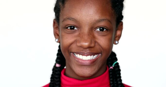 Black child girl smiling at camera and winking, close-up portrait face