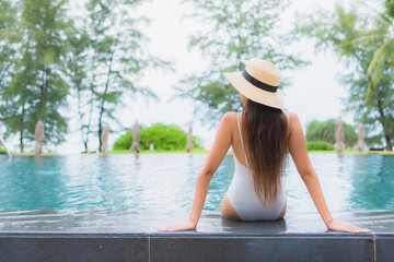 Portrait beautiful young asian woman relax smile leisure around outdoor swimming pool