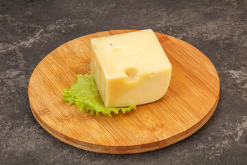 Emmental cheese over wooden board