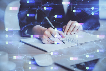 Double exposure of writing hands on background with data solution hologram on front. Technology concept. Close up