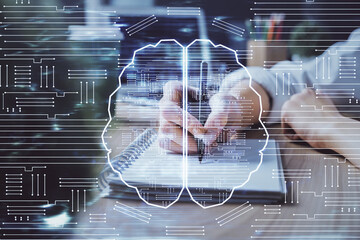 Multi exposure of writing hand on background with brain hologram. Concept of learning.