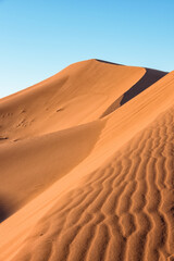 Fototapeta na wymiar Daytime close-up desert dunes of Erg Chigaga, at the gates of the Sahara. Morocco. Concept of travel and adventure.