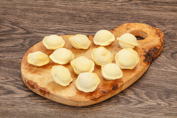 Raw dumplings over board for cooking