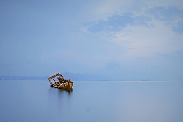 Fisherman traditional wooden boats captured at the coastal areas after sunrise.