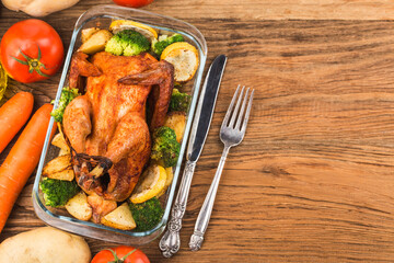 roasted chicken and vegetables on wooden table