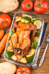 roasted chicken and vegetables on wooden table
