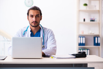 Young male doctor working in the clinic