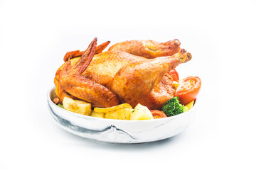 roasted chicken and potatoes on white plate