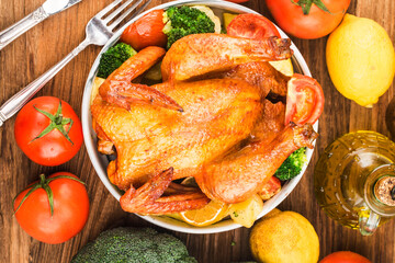 roasted chicken and vegetables on wooden table