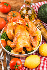 roasted chicken and vegetables on wooden table