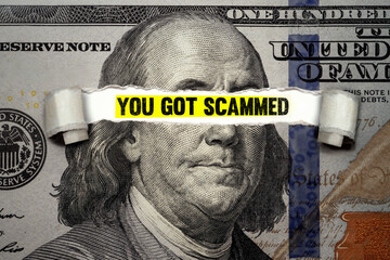 Bill torn revealing words You got Scammed. Idea for What to do if you've been Victim of Scam and...