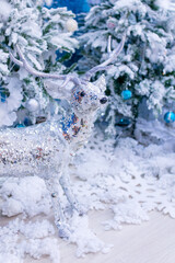 Christmas decorations.  Silver deer among white white Christmas trees.