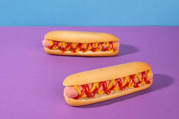 Two fresh hot dogs with ketchup and mustard