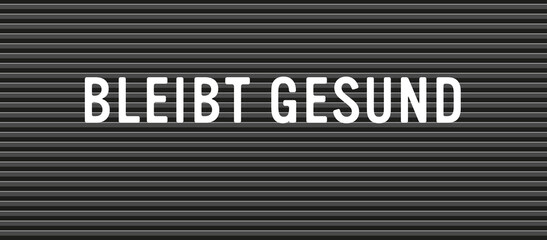bleibt gesund text an buchstaben tafel