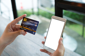 Mockup smart phone image. White screen. Women holding credit card and using mobile phone. Online shopping concept.
